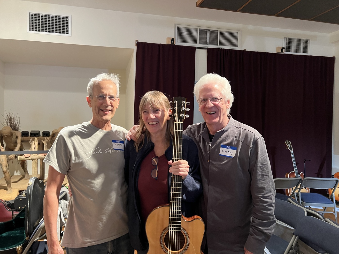 Three attendees gathered outside after a previous guitar event.